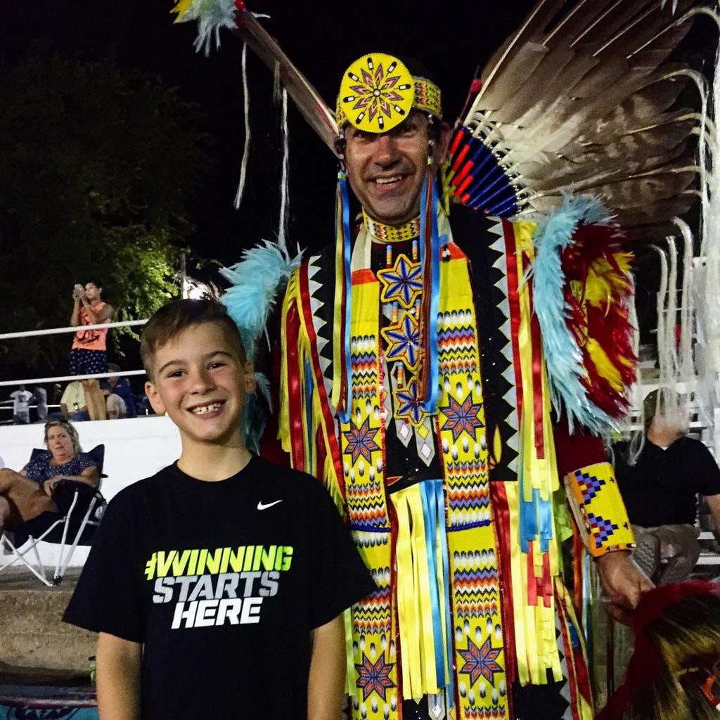 Porter Logan smiling in cultural regalia
