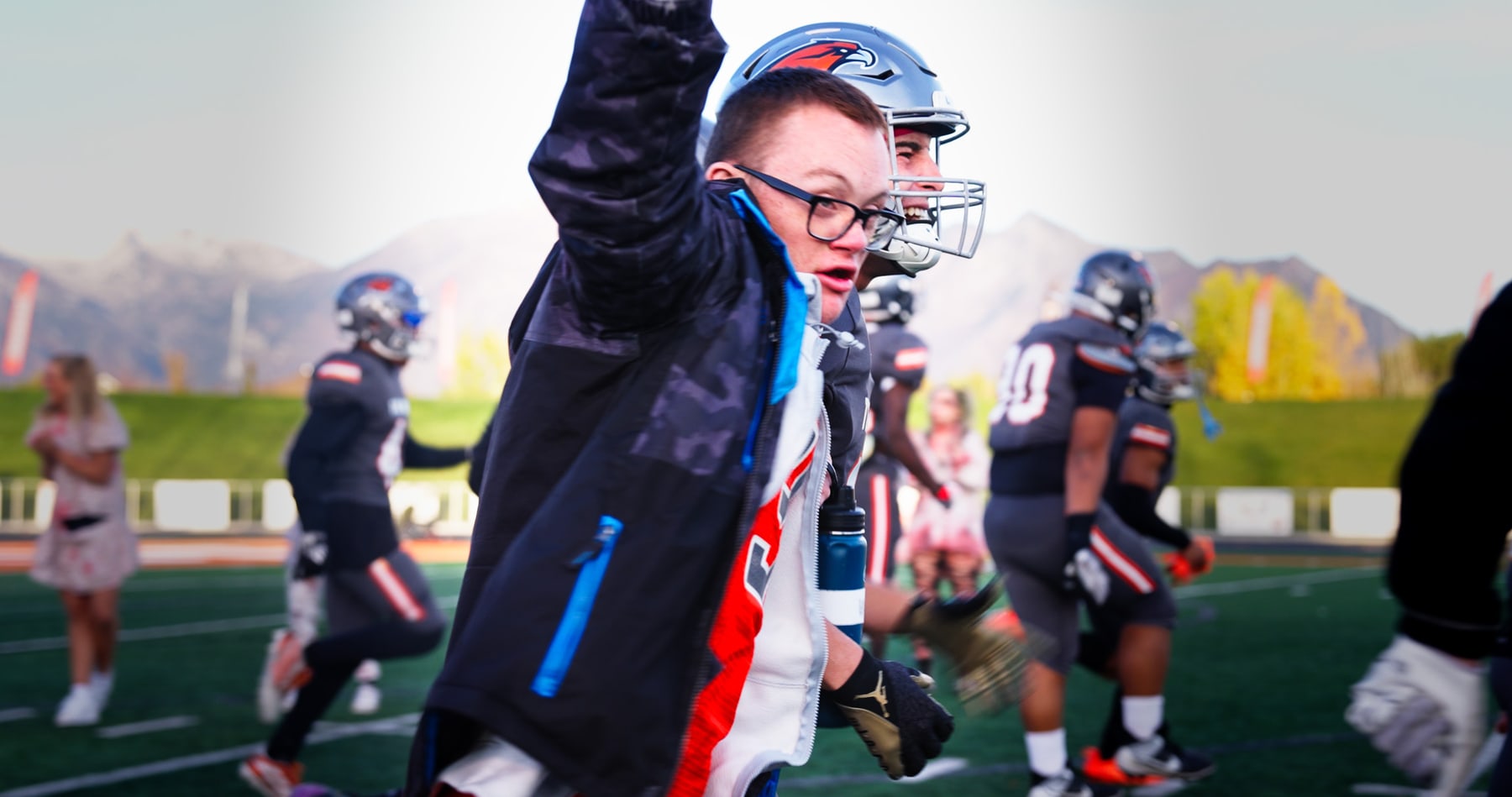 A younger Porter Logan standing near a football field